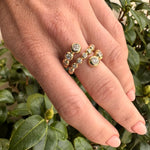 Stunning 14K yellow gold wrap ring featuring delicate bezel-set diamond bubbles, enhancing brilliance and creating a versatile, elegant accent for any occasion. On finger