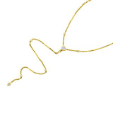 Versatile 14K yellow gold lariat necklace featuring round, pear, and heart-cut diamonds in an elegant, modern design. With a detachable feature that transforms into a matching bracelet set, this piece offers understated luxury and adaptable styling. Close up. 