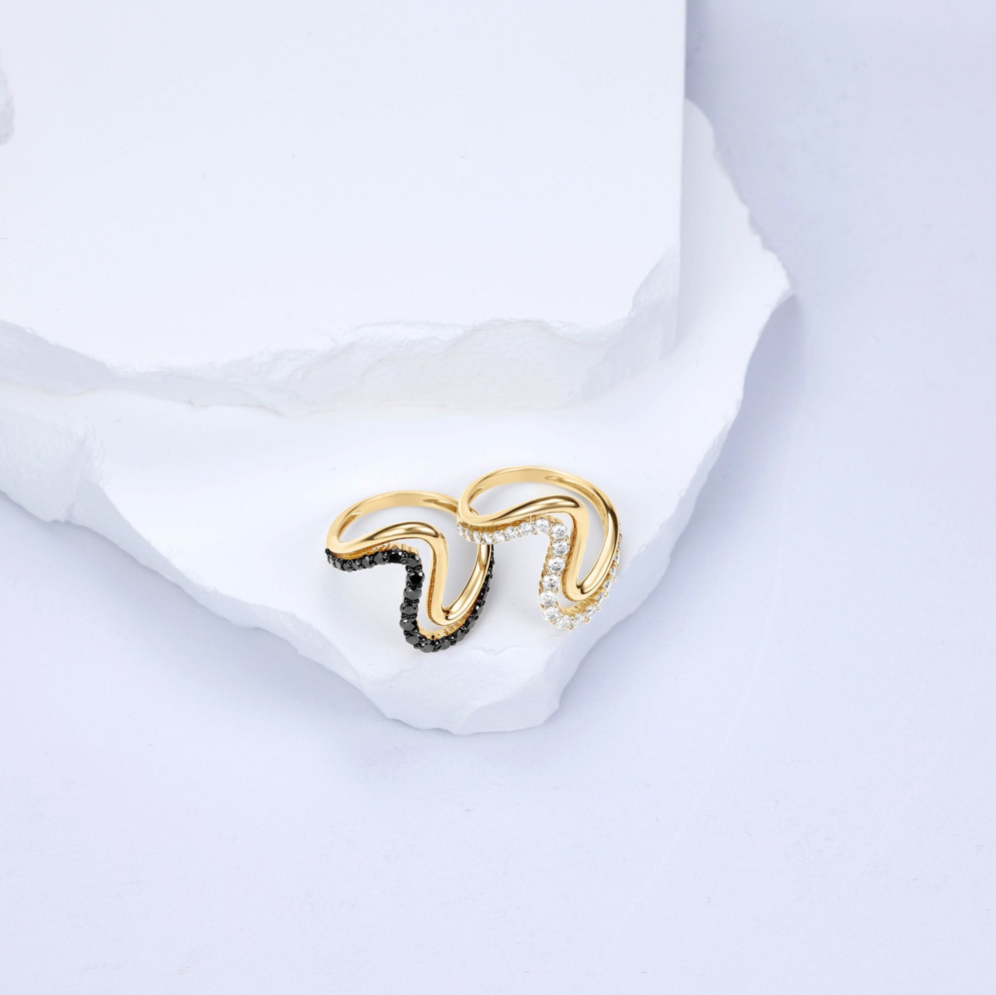 Striking 14K yellow gold wave ring featuring a bold double-wave design, accented with captivating black diamonds and sleek black rhodium details for modern elegance. Displayed with the white diamonds.  Top view. 