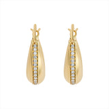 Elegant 14K yellow gold domed saddle hoop earrings featuring a curved silhouette with a row of 0.42ct channel-set diamonds, measuring 0.75 inches wide and weighing 6.97g.