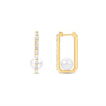 Stunning elongated hoop earrings featuring a sleek rectangular design adorned with diamond baguettes along the outside and a beautiful pearl solitaire at the bottom, crafted in 14K gold for a sophisticated statement. Front and side views. 