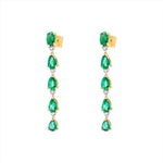 Elegant 14K yellow gold drop earrings featuring a linear arrangement of vivid pear-shaped emeralds totaling 3.52ct, each linked with a prong-set diamond (0.29ct), for a graceful and radiant look.