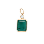 Elegant pendant featuring a large emerald-cut Colombian emerald paired with a diamond accent, framed in 14K yellow gold, showcasing timeless design and exceptional craftsmanship.