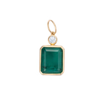 Elegant pendant featuring a large emerald-cut Colombian emerald paired with a diamond accent, framed in 14K yellow gold, showcasing timeless design and exceptional craftsmanship.