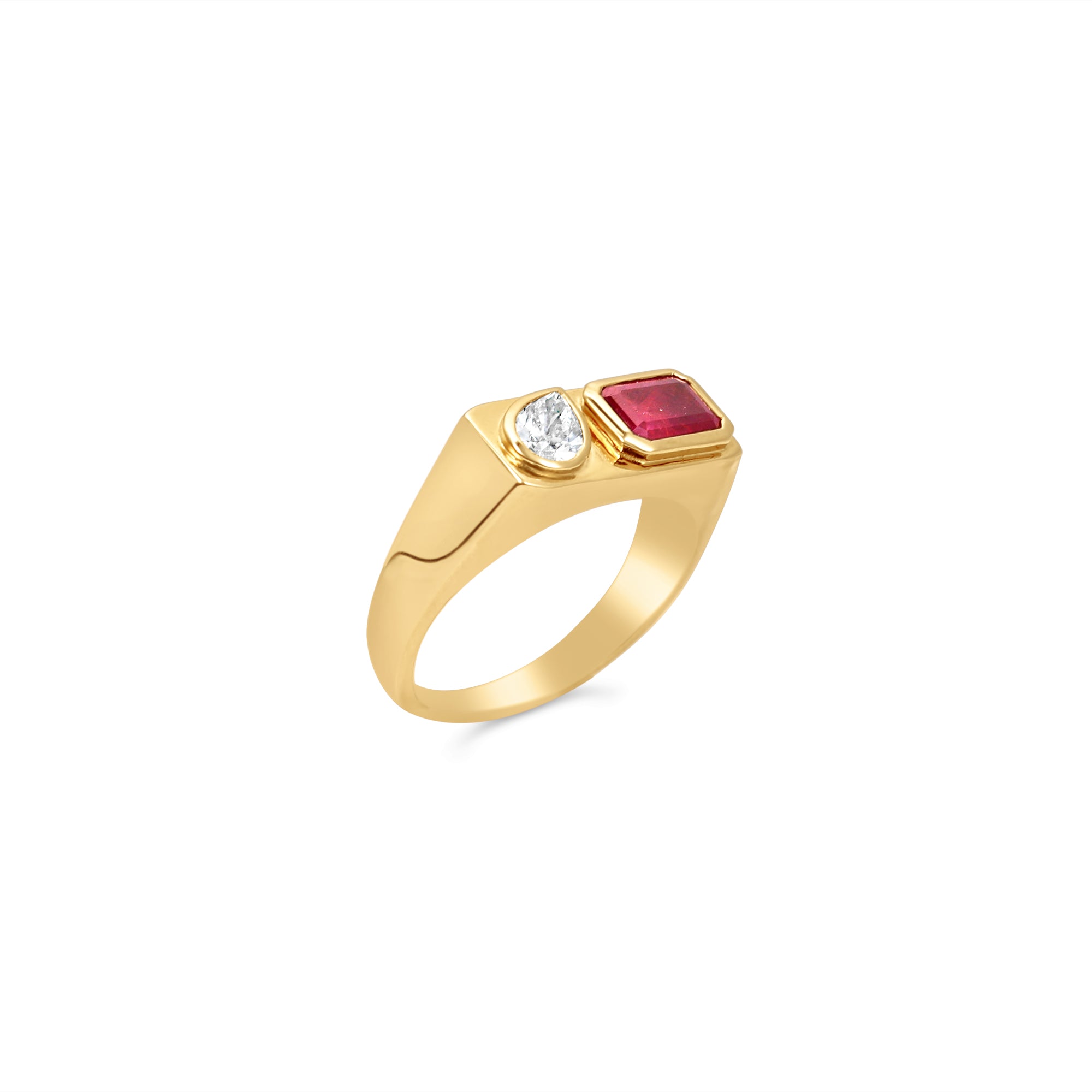 Striking east-west ring crafted in 14K yellow gold, featuring a bezel-set emerald-cut ruby and a sparkling pear-shaped diamond, exuding sophistication and timeless charm as a bold statement piece. Detail of full ring. 