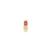 Striking east-west ring crafted in 14K yellow gold, featuring a bezel-set emerald-cut ruby and a sparkling pear-shaped diamond, exuding sophistication and timeless charm as a bold statement piece. Front facing.