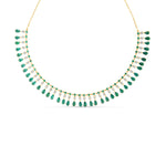 Captivating bib necklace crafted in 14K yellow gold, featuring vibrant emeralds and sparkling diamonds delicately arranged on an adjustable chain for timeless elegance and versatility. Close Up. 