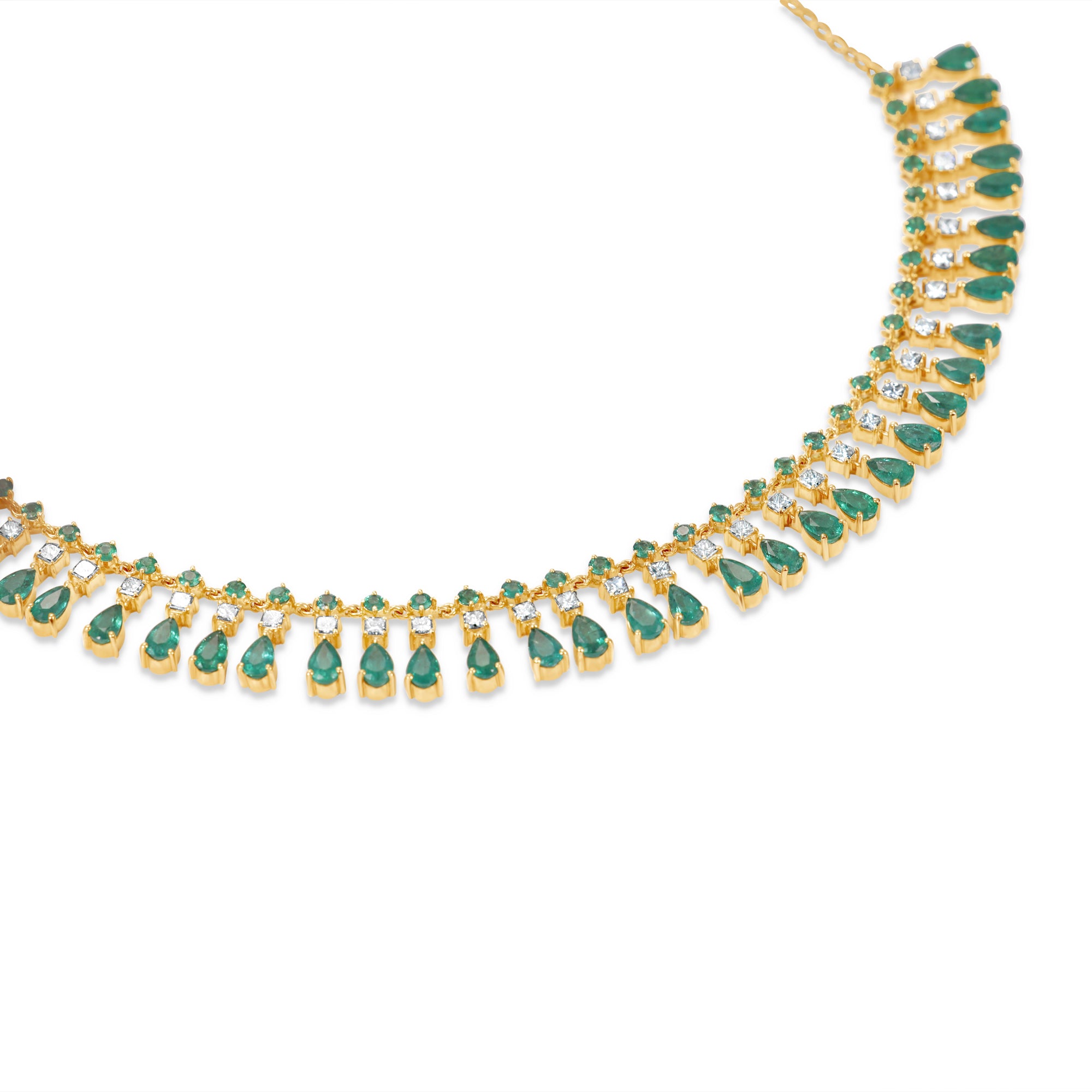 Captivating bib necklace crafted in 14K yellow gold, featuring vibrant emeralds and sparkling diamonds delicately arranged on an adjustable chain for timeless elegance and versatility. Side view. 