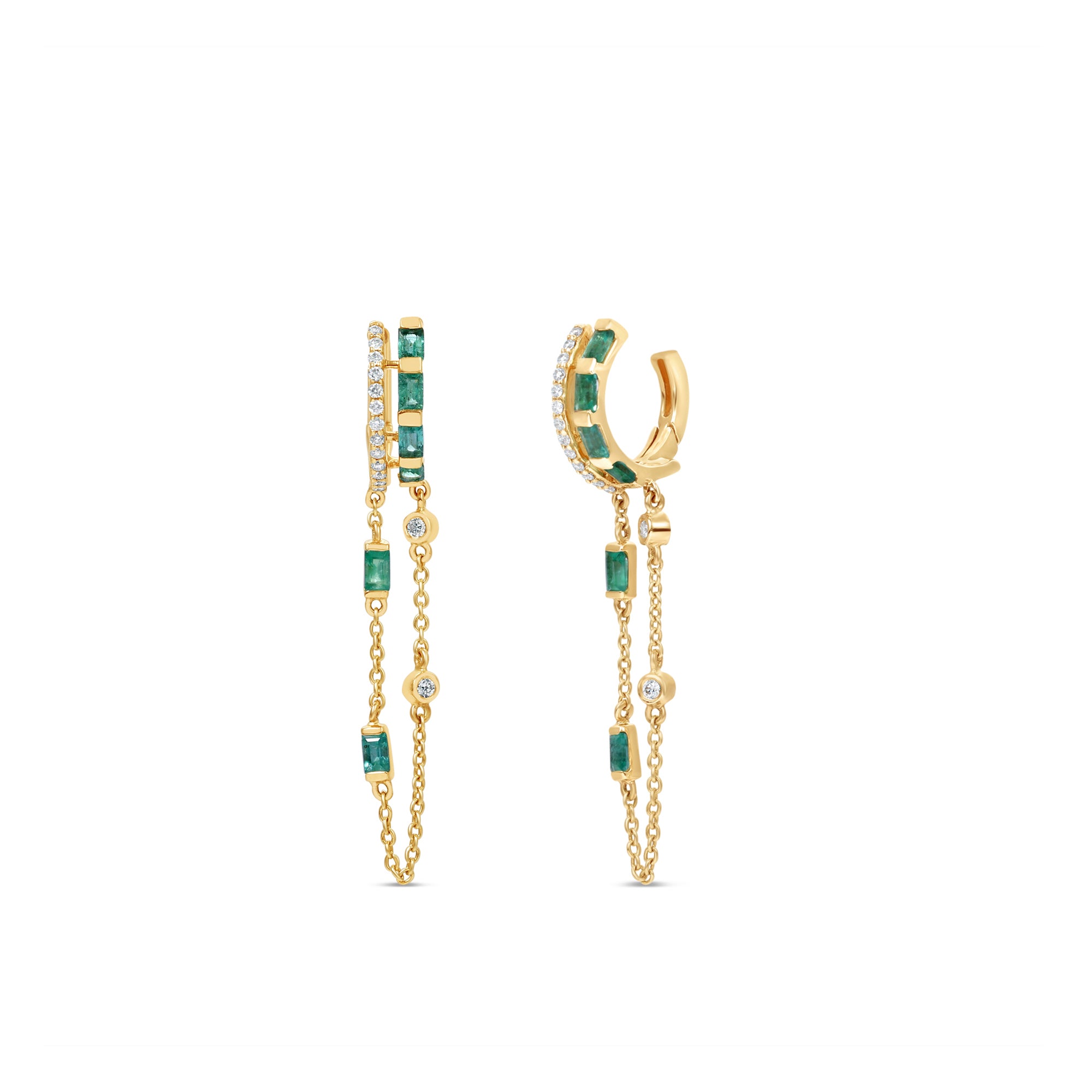 Captivating double hoop earrings featuring shimmering diamonds and vibrant emeralds in a double huggie design, accentuated by delicate dangling chains for a blend of classic sophistication and modern allure. Front and side view. 