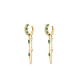 Captivating double hoop earrings featuring shimmering diamonds and vibrant emeralds in a double huggie design, accentuated by delicate dangling chains for a blend of classic sophistication and modern allure. Side view, close up.
