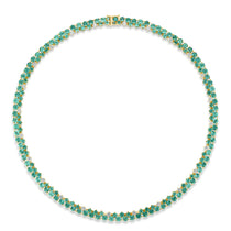 Mesmerizing dual tennis necklace crafted in 14K yellow gold, featuring vivid emeralds and sparkling diamond accents, offering a sophisticated and timeless design for elevating any ensemble.