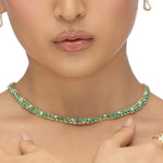 Mesmerizing dual tennis necklace crafted in 14K yellow gold, featuring vivid emeralds and sparkling diamond accents, offering a sophisticated and timeless design for elevating any ensemble.