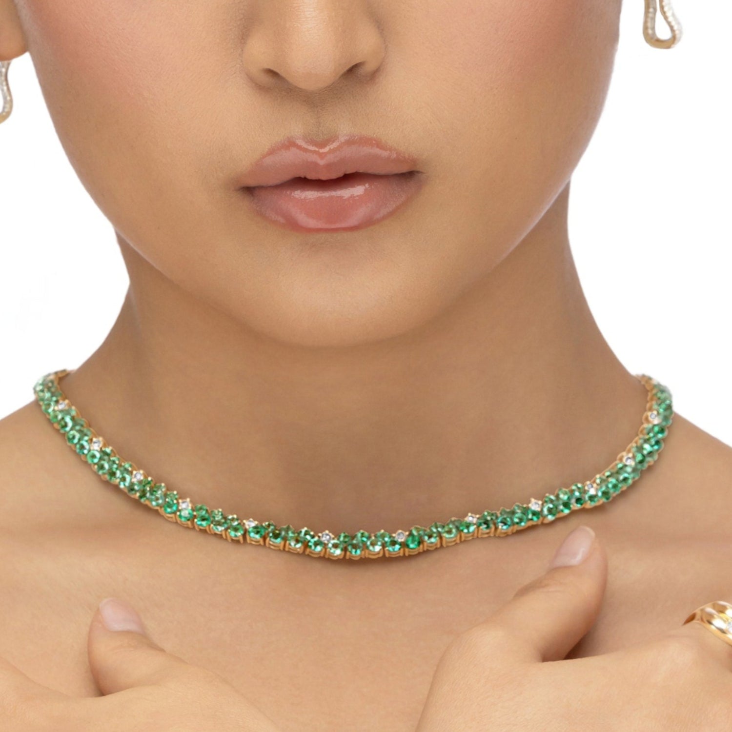 Mesmerizing dual tennis necklace crafted in 14K yellow gold, featuring vivid emeralds and sparkling diamond accents, offering a sophisticated and timeless design for elevating any ensemble.