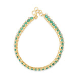 Timeless 14K yellow gold line bracelet featuring vibrant emeralds and radiant diamonds, offering a bold yet sophisticated design with an adjustable fit for versatile wear.