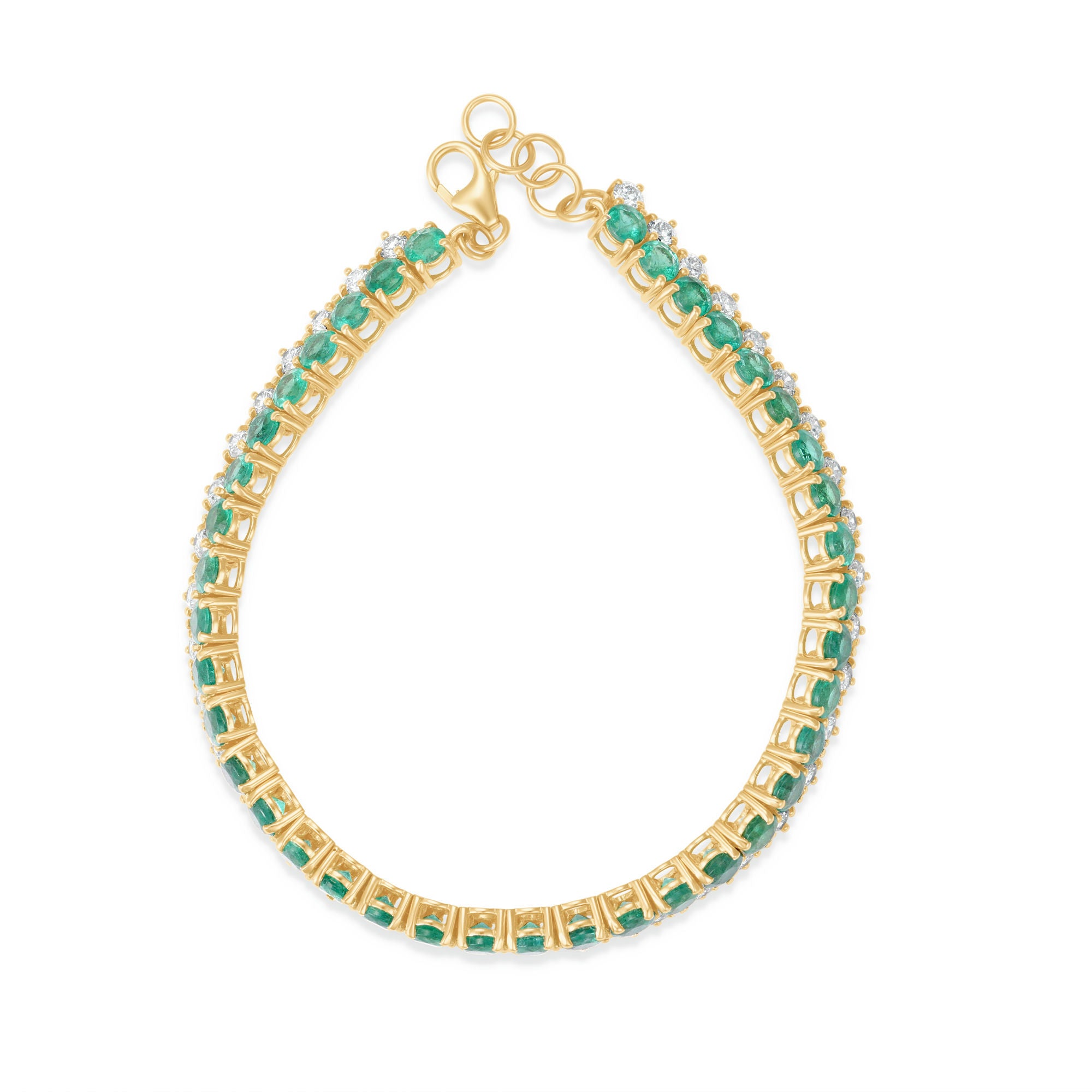 Timeless 14K yellow gold line bracelet featuring vibrant emeralds and radiant diamonds, offering a bold yet sophisticated design with an adjustable fit for versatile wear.