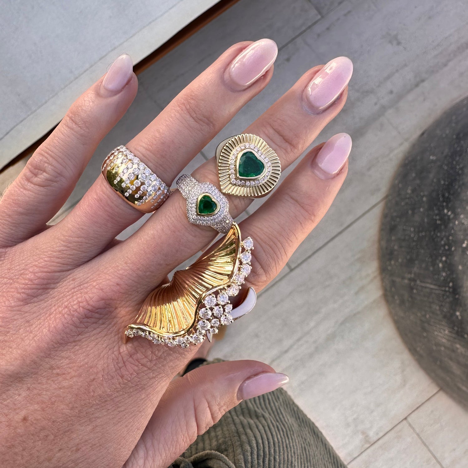 A 14k dual-tone gold ring featuring a 0.47ct heart-shaped emerald at center, surrounded by 0.75ct of pavé-set diamonds across 81 stones.