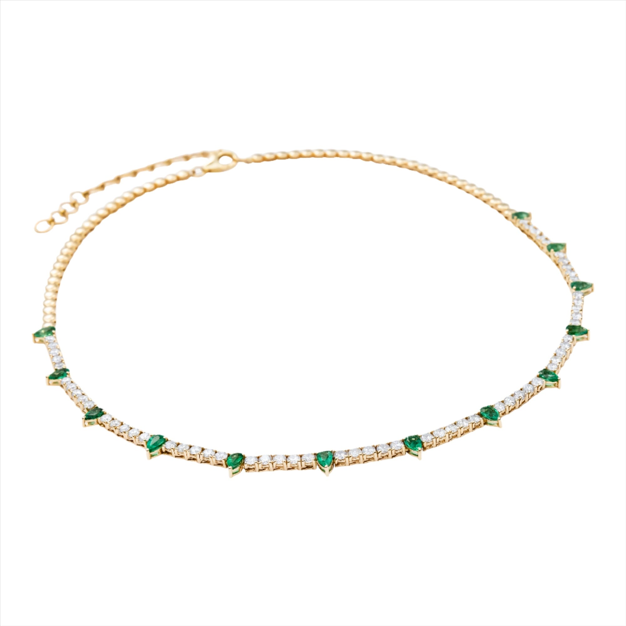 Adjustable 14K yellow gold tennis necklace featuring 2.13ct of pear-shaped emeralds and 4.51ct of G-H VS diamonds, with an 18-inch maximum length and total weight of 17.38g. A bold and vibrant take on the classic tennis necklace.
