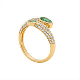 Elegant 14K yellow gold serpent-inspired bypass ring featuring two pear-shaped bezel-set emeralds (0.7ct) accented by 0.5ct of G-H VS pavé diamonds—perfect for day or night wear.