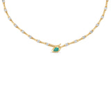 Luxurious 14K yellow gold serpent necklace featuring a vibrant green emerald complemented by shimmering diamonds, with an adjustable design that exudes timeless elegance and individuality. Close Up