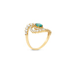 Stunning 14K yellow gold spiral ring featuring a vivid oval-cut emerald at its center, encircled by two spirals of sparkling round brilliant-cut diamonds, blending modern design with timeless elegance. Side angle. 