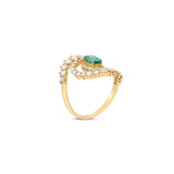 Stunning 14K yellow gold spiral ring featuring a vivid oval-cut emerald at its center, encircled by two spirals of sparkling round brilliant-cut diamonds, blending modern design with timeless elegance. Side angle. 