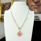 The Fleur de Charme Pendant reimagines the classic floral motif with bold color and architectural precision. Featuring a central gemstone framed by six sculpted, petal-shaped stones, this signature silhouette is crafted in solid 14K gold. Designed to lie flat when worn, the pendant offers subtle dimension and a refined presence—perfect for layering or wearing on its own.

Metal: 14K Solid Gold
Design: Center stone with six precision-cut gemstone petals
Details: Thoughtfully weighted to lay flat against the 