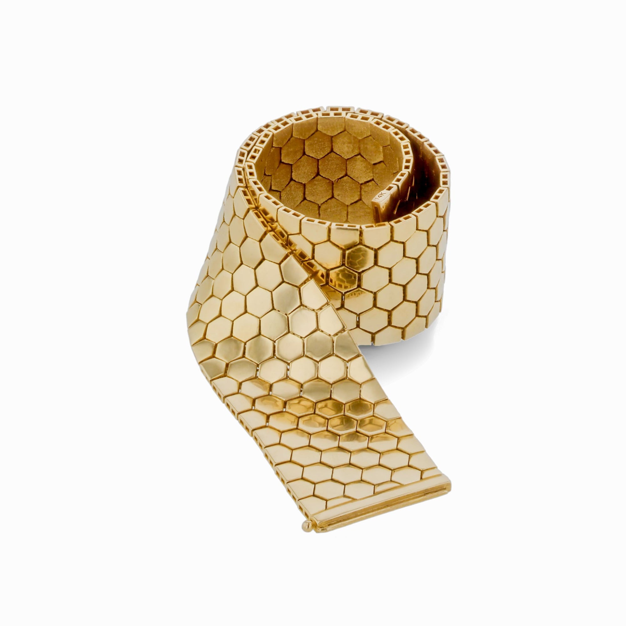 Elegant 14K yellow gold flexible reversible bracelet featuring a dual-sided honeycomb design with matte and shiny finishes, secured with an innovative invisible side slide clasp for effortless style. Rolled up detail.