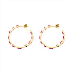 Striking 14K yellow gold hoop earrings featuring an inside-out design with 3.21ct of floating mixed-shape rubies, measuring 42.9mm in diameter for a bold and luxurious statement.