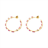 Striking 14K yellow gold hoop earrings featuring an inside-out design with 3.21ct of floating mixed-shape rubies, measuring 42.9mm in diameter for a bold and luxurious statement.