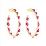 Striking 14K yellow gold hoop earrings featuring an inside-out design with 3.21ct of floating mixed-shape rubies, measuring 42.9mm in diameter for a bold and luxurious statement.