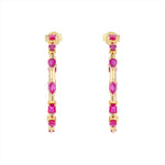 Striking 14K yellow gold hoop earrings featuring an inside-out design with 3.21ct of floating mixed-shape rubies, measuring 42.9mm in diameter for a bold and luxurious statement.