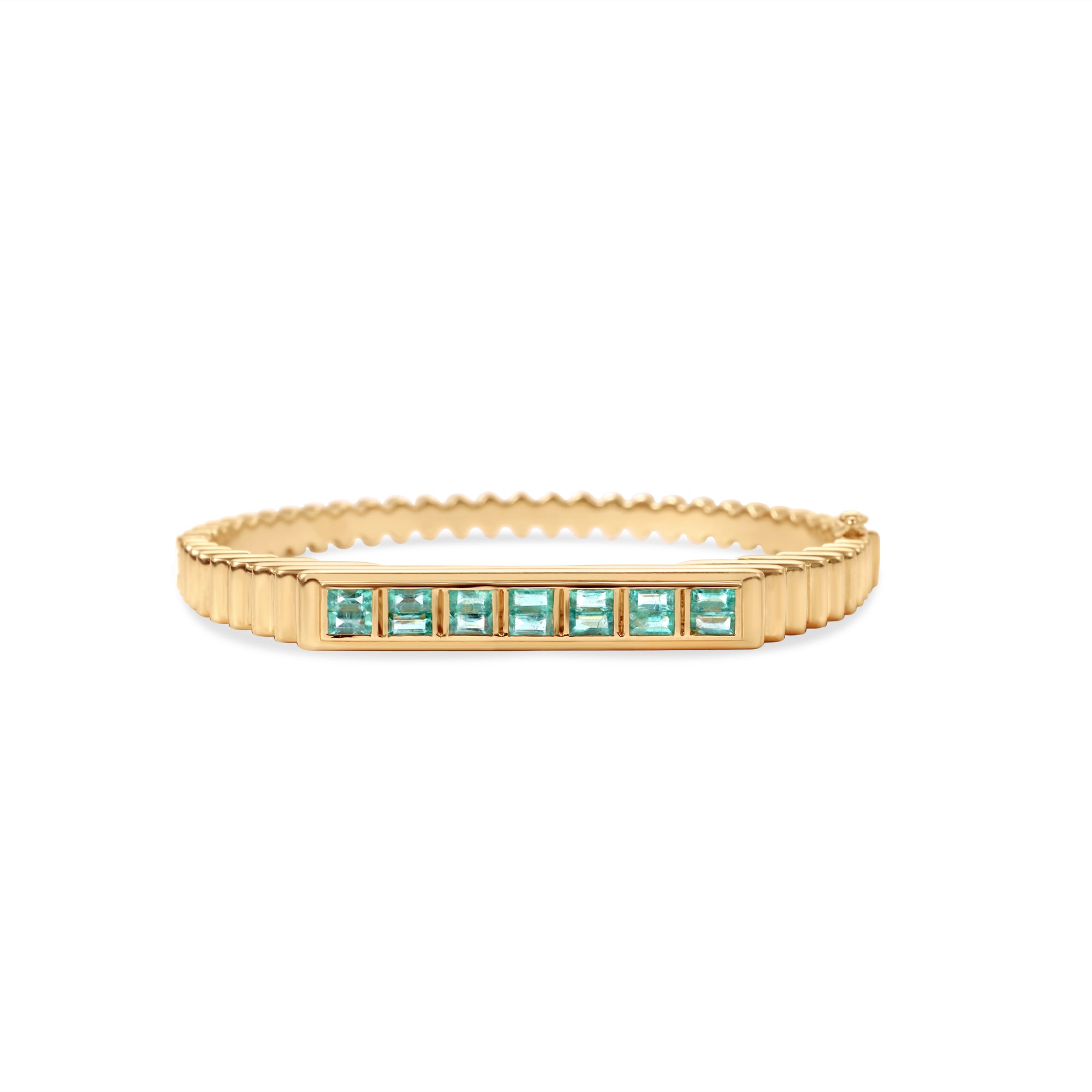Timeless 14K yellow gold fluted bangle featuring vibrant bezel-set baguette emeralds, offering a refined design that adds a touch of elegance and color to any ensemble. Front View