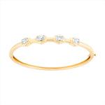 14K yellow gold hinge bangle bracelet featuring four G-H VS oval diamonds totaling 3.59ct. With a 6.5-inch inner circumference and a total weight of 11.15g, this modern diamond bangle is feminine, sleek, and timeless.