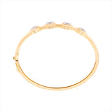 14K yellow gold hinge bangle bracelet featuring four G-H VS oval diamonds totaling 3.59ct. With a 6.5-inch inner circumference and a total weight of 11.15g, this modern diamond bangle is feminine, sleek, and timeless.