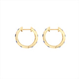 Striking 14K yellow gold huggie earrings featuring 1.79ct of vibrant blue sapphires, set in 1/2-inch wide hoops for a colorful and elegant everyday accessory.