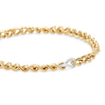 Exquisite 14K two-tone gold curb link chain necklace featuring a single accent link adorned with 498 pavé-set diamonds, offering a refined balance of elegance and luxury. Close up of pavé-set diamonds at a side angle
