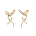 Charming 14K yellow gold bow stud earrings adorned with sparkling diamonds, offering a whimsical yet elegant touch to elevate any outfit. Close up.