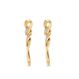 Chic 14K yellow gold chain link earrings featuring a diamond-encrusted link and an elongated pear-shaped link, adding sophistication and elegance to any outfit. Side angle close up. 