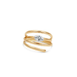 Elegant 14K yellow gold spiral ring featuring a sleek marquise-cut diamond, blending timeless luxury with modern minimalism, perfect for stacking or wearing alone. Close up, angled. 
