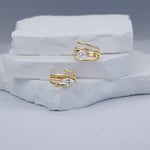Elegant 14K yellow gold spiral rings in two versions featuring a sleek marquise-cut diamond, blending timeless luxury with modern minimalism, perfect for stacking or wearing alone. 