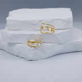 Elegant 14K yellow gold spiral rings in two versions featuring a sleek marquise-cut diamond, blending timeless luxury with modern minimalism, perfect for stacking or wearing alone. 