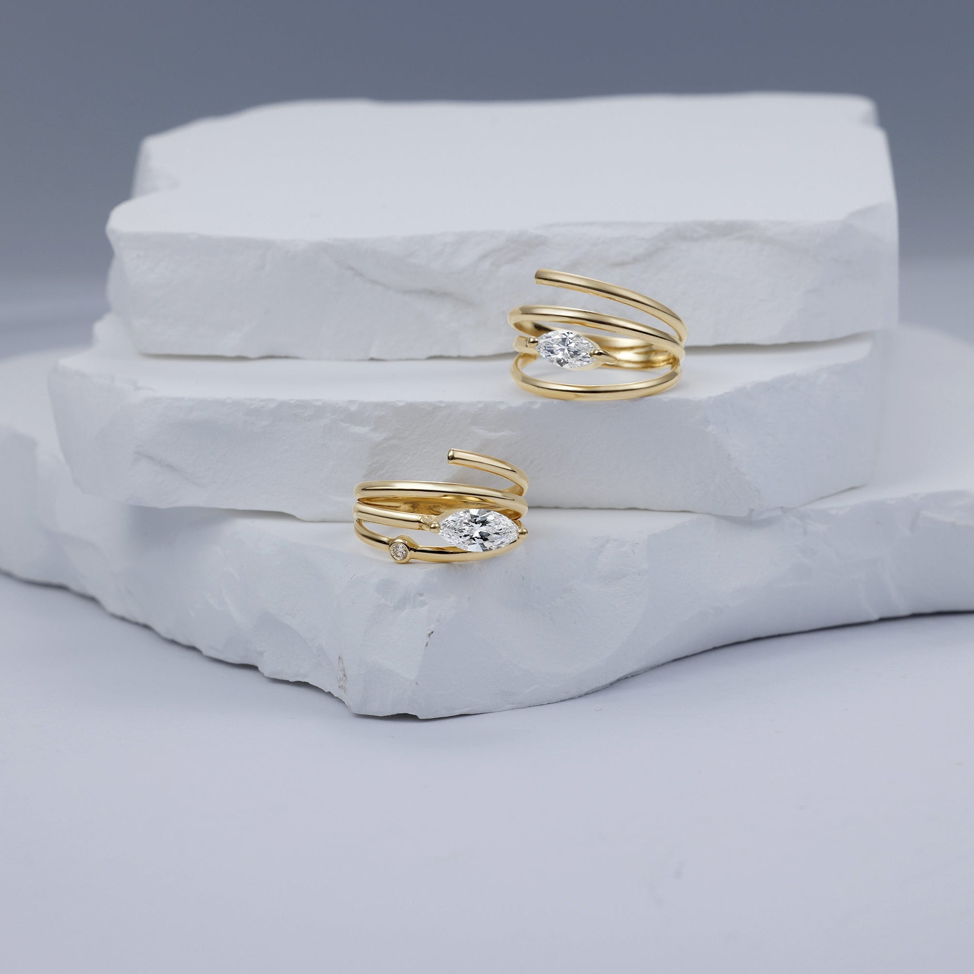 Elegant 14K yellow gold spiral ring featuring a sleek marquise-cut diamond, blending timeless luxury with modern minimalism, perfect for stacking or wearing alone. Paired with the small marquise ring. 