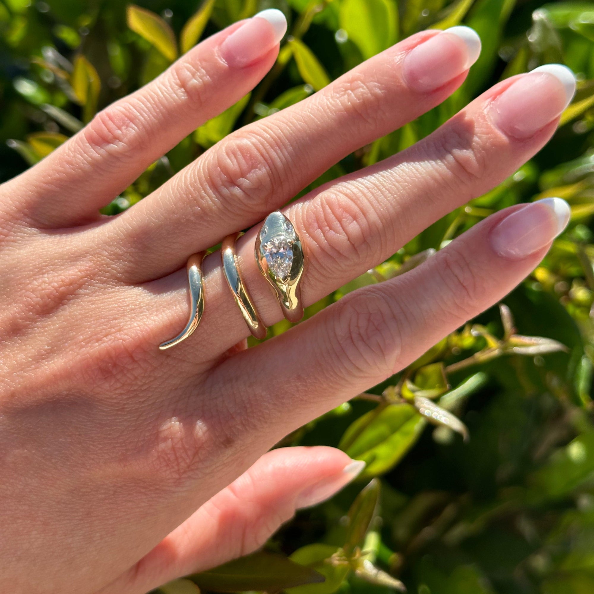 Nature-inspired 14K yellow gold serpent wrap ring featuring exquisite details and sparkling diamonds on its head, adding a touch of enchantment and elegance to any jewelry collection. On hand. 