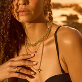 Nature-inspired 14K yellow gold serpent wrap ring featuring exquisite details and sparkling diamonds on its head, adding a touch of enchantment and elegance to any jewelry collection. On Model 