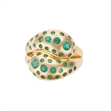 Beautiful 14K yellow gold knot ring featuring a vibrant spray of Zambian emeralds totaling 0.98ct, offering a luxurious and modern twist on a timeless design.