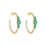 Major statement 14K yellow gold hoop earrings featuring 3.15ct of vibrant graduated emeralds and 3.05ct of G-H VS diamonds, sized at 1.5 inches for maximum impact and brilliance.