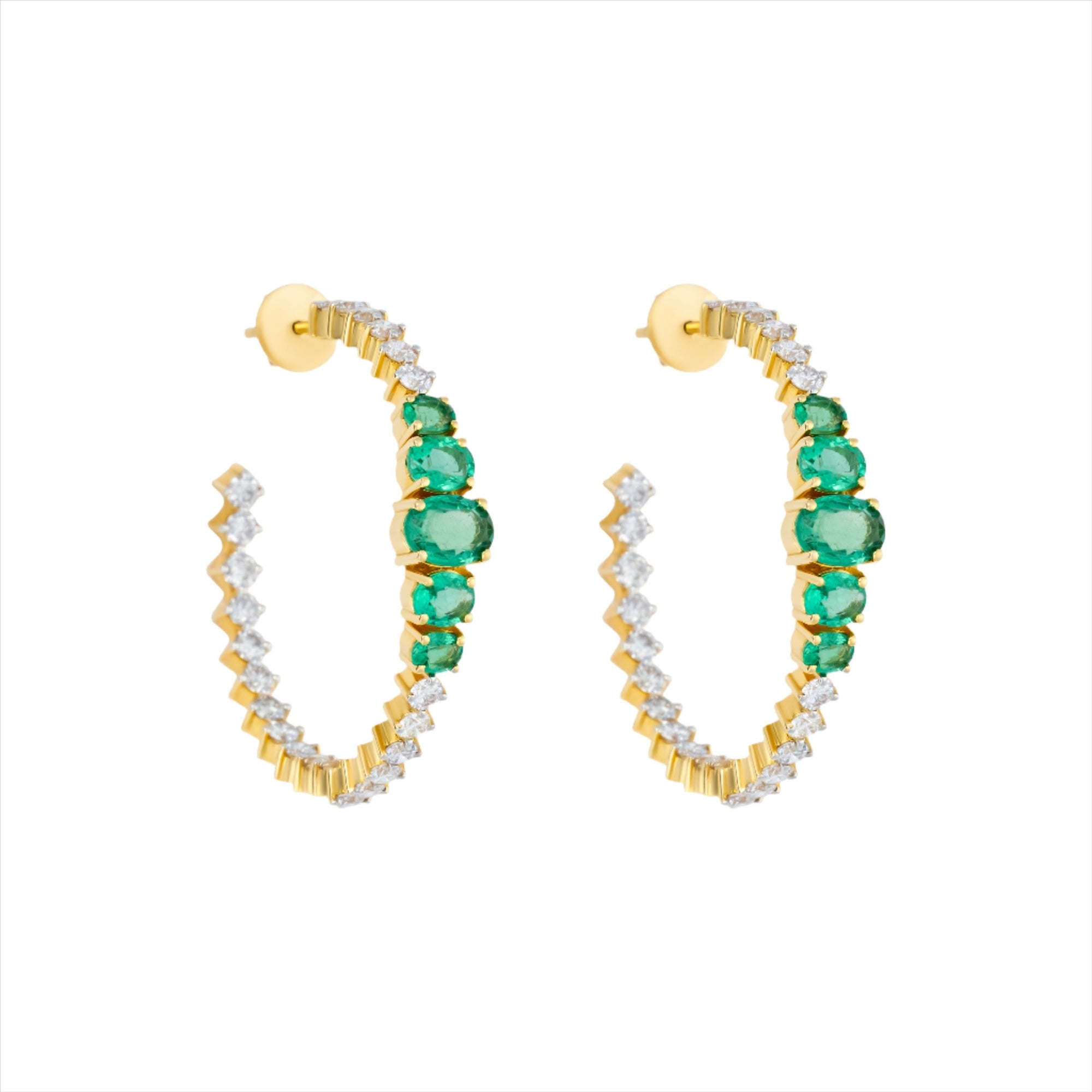 Major statement 14K yellow gold hoop earrings featuring 3.15ct of vibrant graduated emeralds and 3.05ct of G-H VS diamonds, sized at 1.5 inches for maximum impact and brilliance.