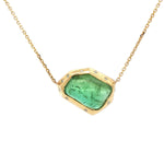 One-of-a-kind 18K yellow gold pendant featuring a 14.46ct freeform green tourmaline framed in a sculptural bezel with scattered diamond accents. Includes adjustable 16–18 inch gold chain.