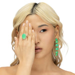 Luxurious 18K yellow gold halo ring featuring a luminous hand-carved chrysoprase cabochon, elegantly framed by brilliant-cut diamonds, blending natural beauty with timeless sophistication.