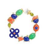Exquisite 18K yellow gold mixed gemstone bracelet featuring a vibrant medley of hand-carved lapis, peridot, aquamarine, coral, and chrysoprase, accented with delicate diamonds for added brilliance and artistic luxury.